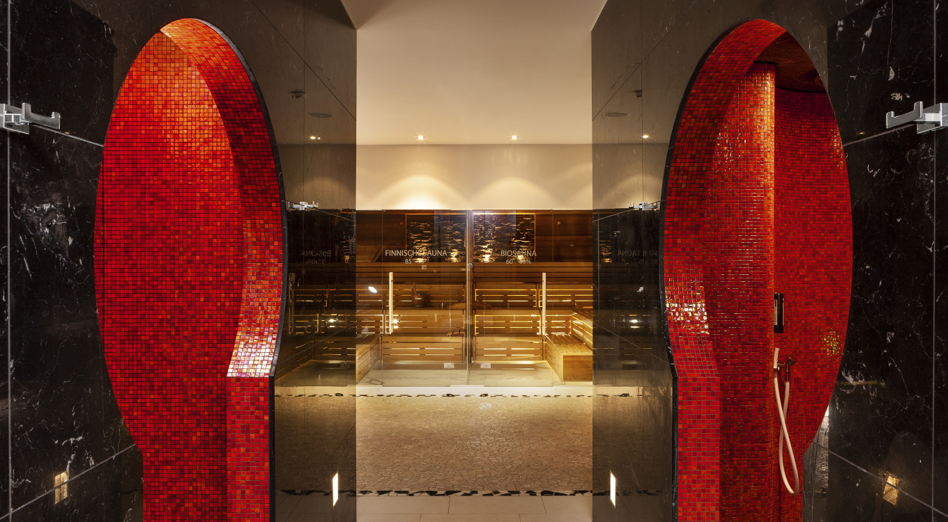 a glass door with red tile walls