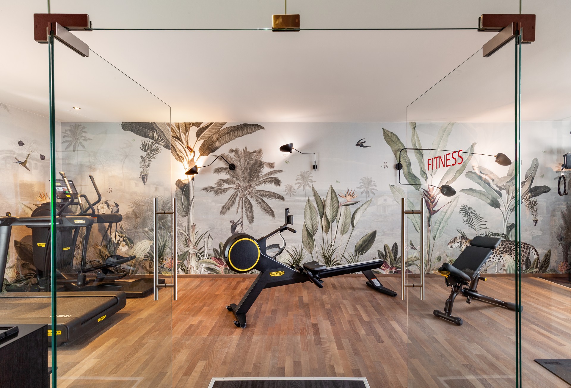 a room with exercise equipment and a wallpaper