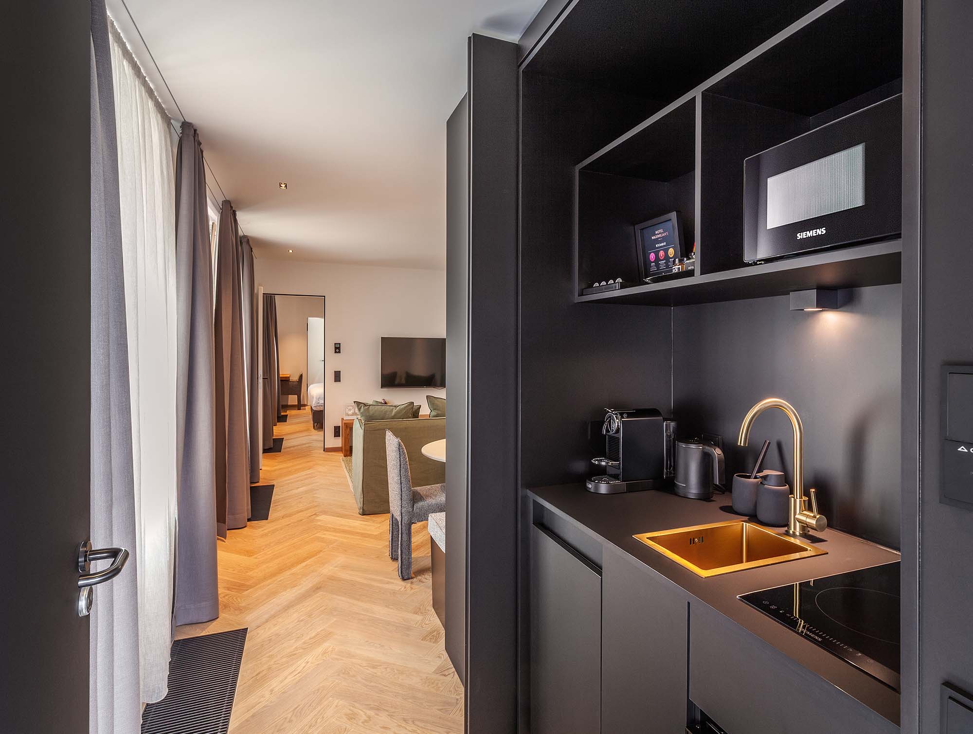 a kitchen with a microwave and a wood floor