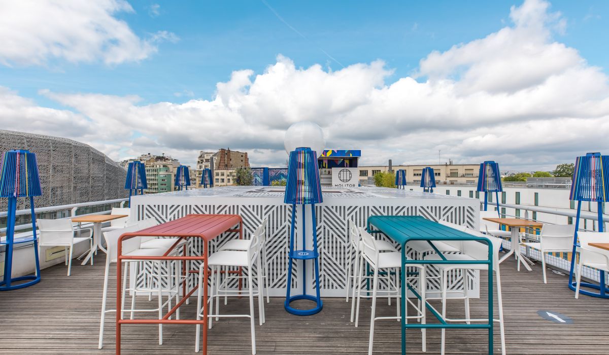 a group of colorful tables and chairs on a rooftop