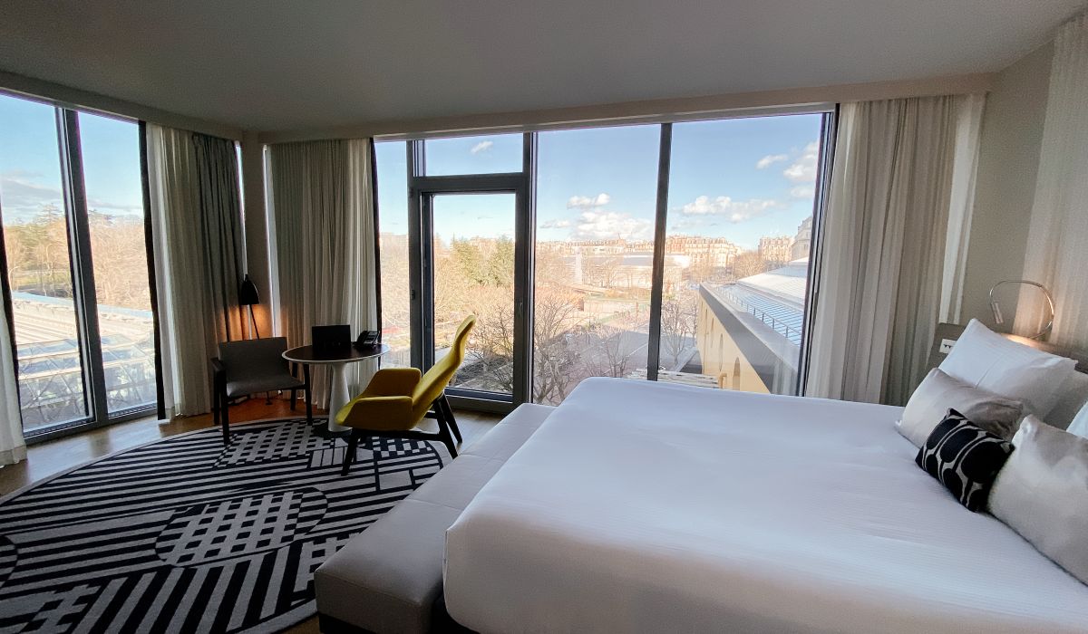 a room with a bed and a chair and a table