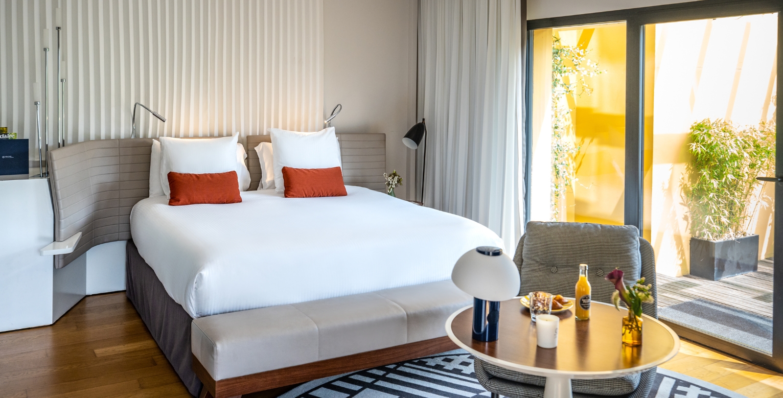 a bed with a table and chairs in a room