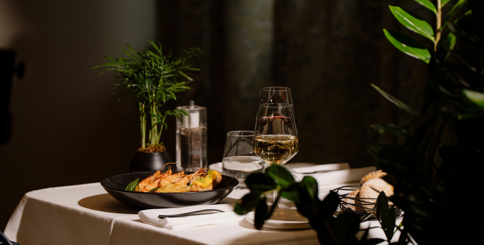 a table with food and wine glasses