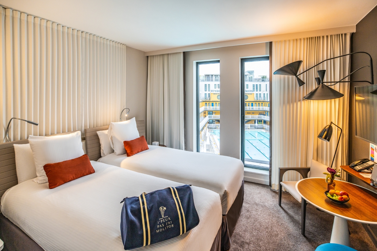a hotel room with two beds and a table