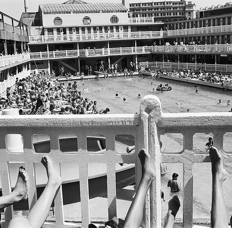 a group of people sitting on a balcony