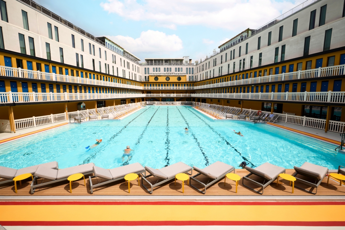 a pool with lounge chairs and a deck
