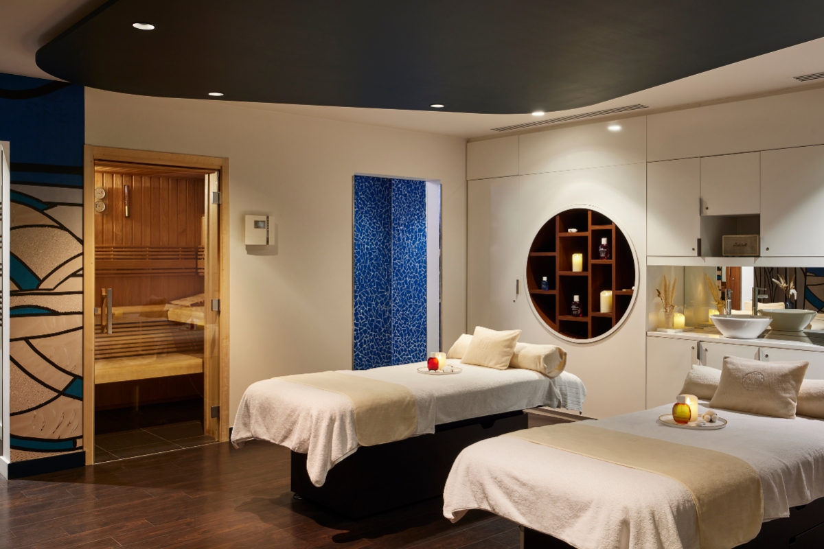 a massage room with white beds