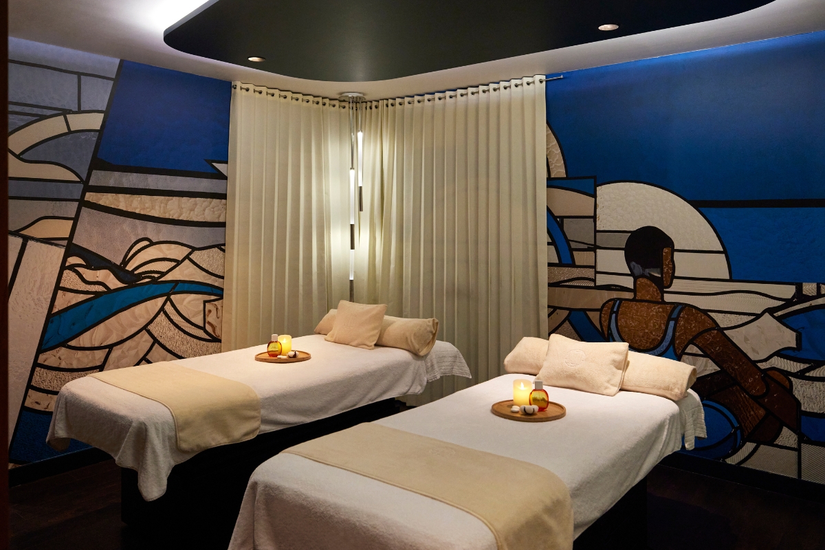 a massage room with two beds