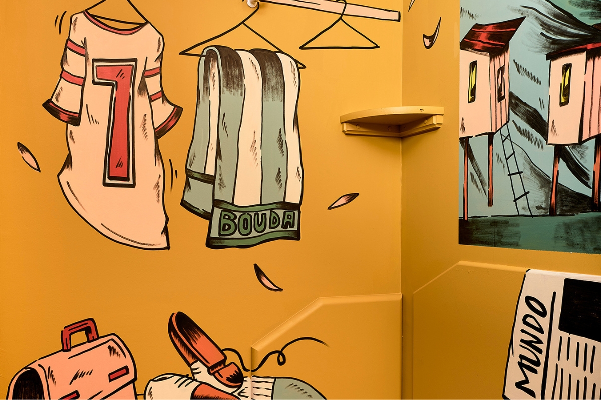 a yellow wall with drawings on it