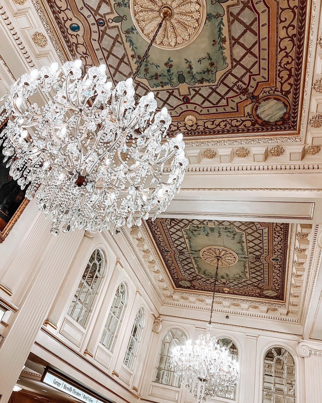 a chandelier from the ceiling of a large room