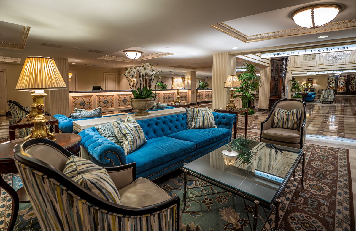 a room with a blue couch and chairs