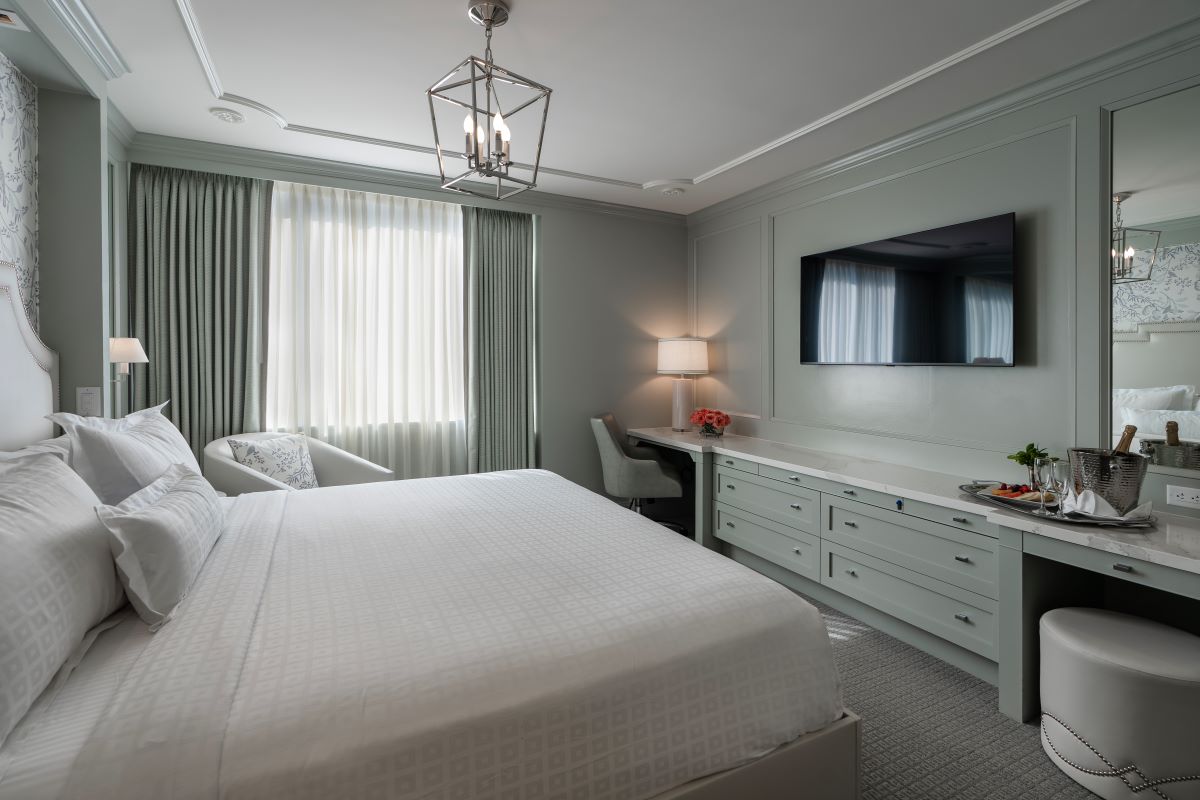 a bedroom with a bed and a mirror