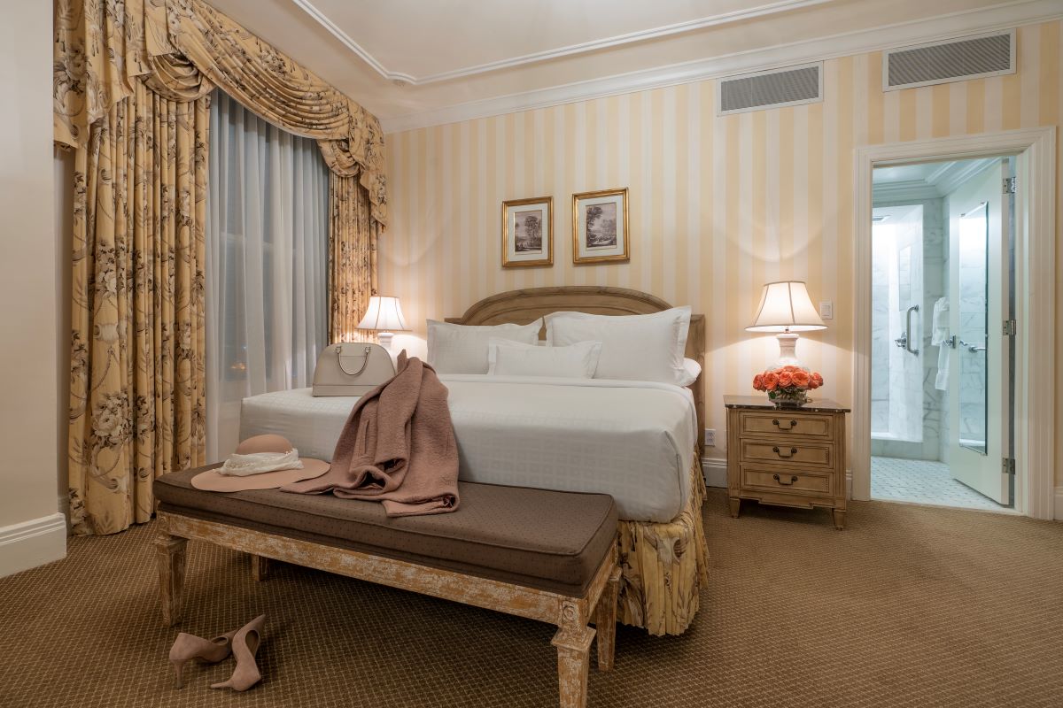 a bedroom with a bed and a bench