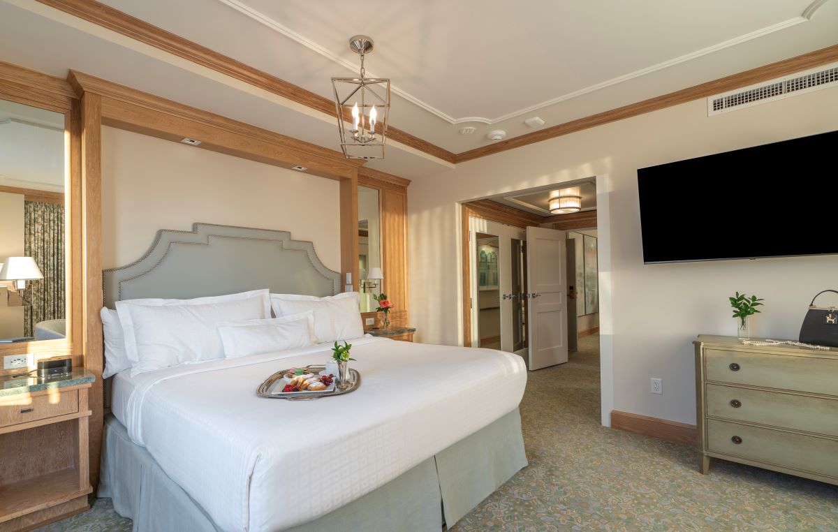 a bed with a tray of food on it