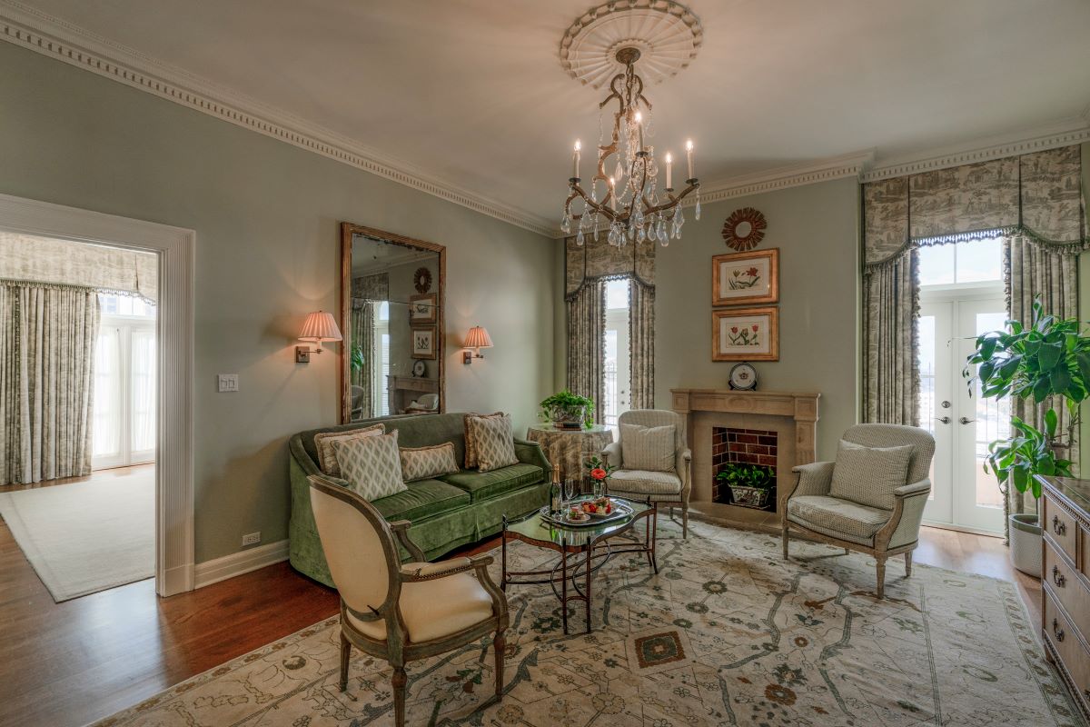 a living room with a chandelier and a couch