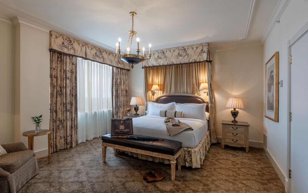 a bedroom with a bed and a chandelier