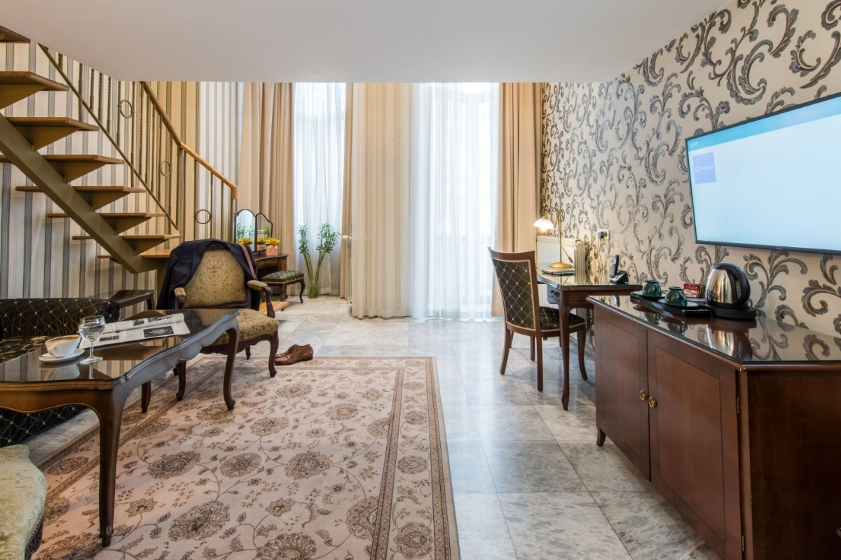 a room with a television and a staircase