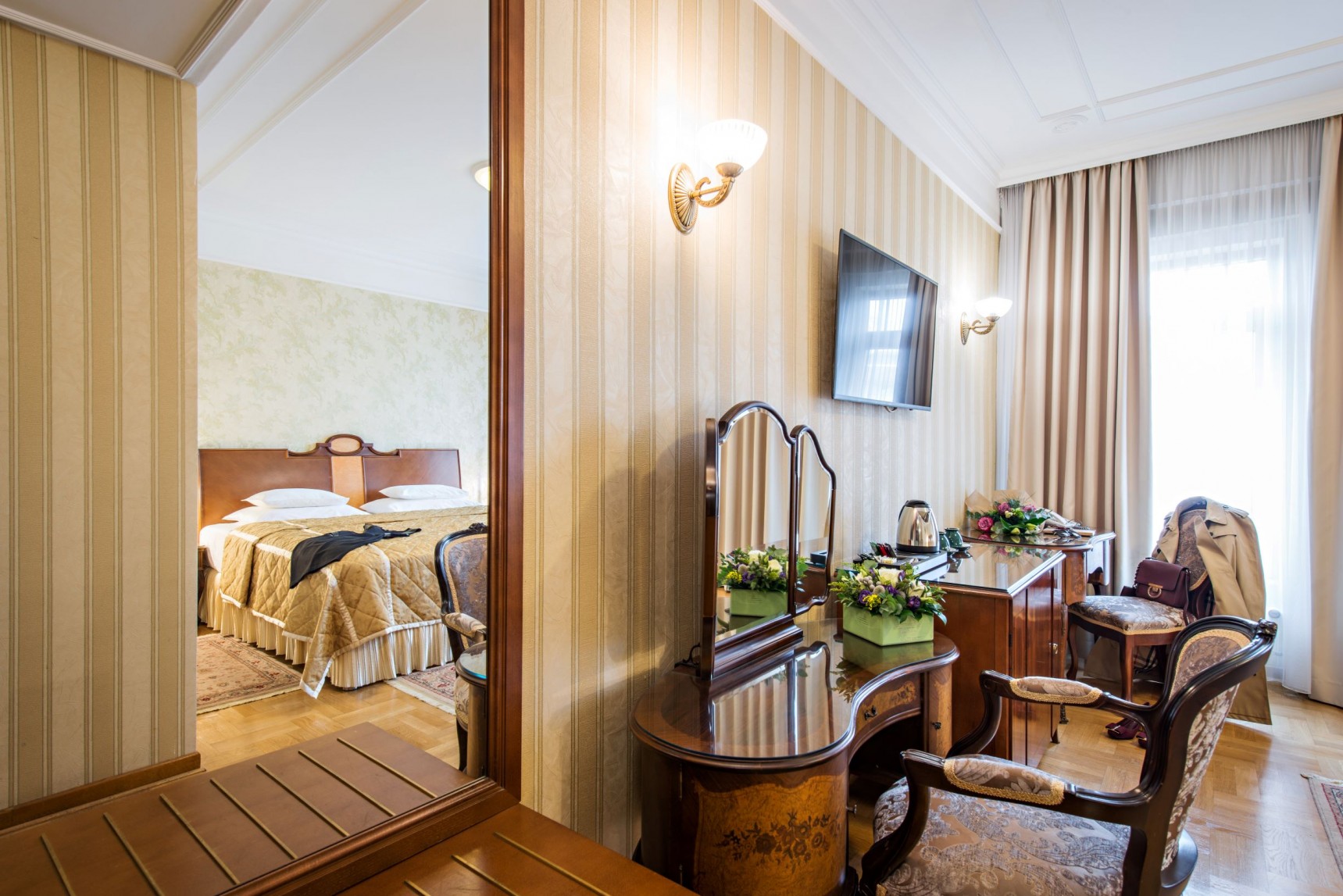 a room with a mirror and a bed