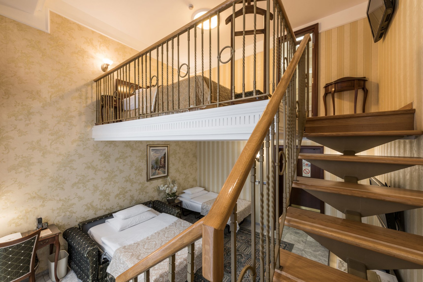 a two story bedroom with a double bed and a staircase