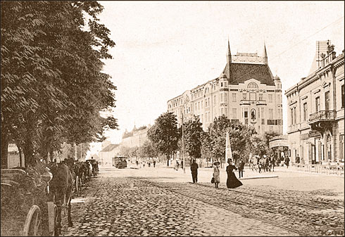 a group of people walking on a cobblestone street
