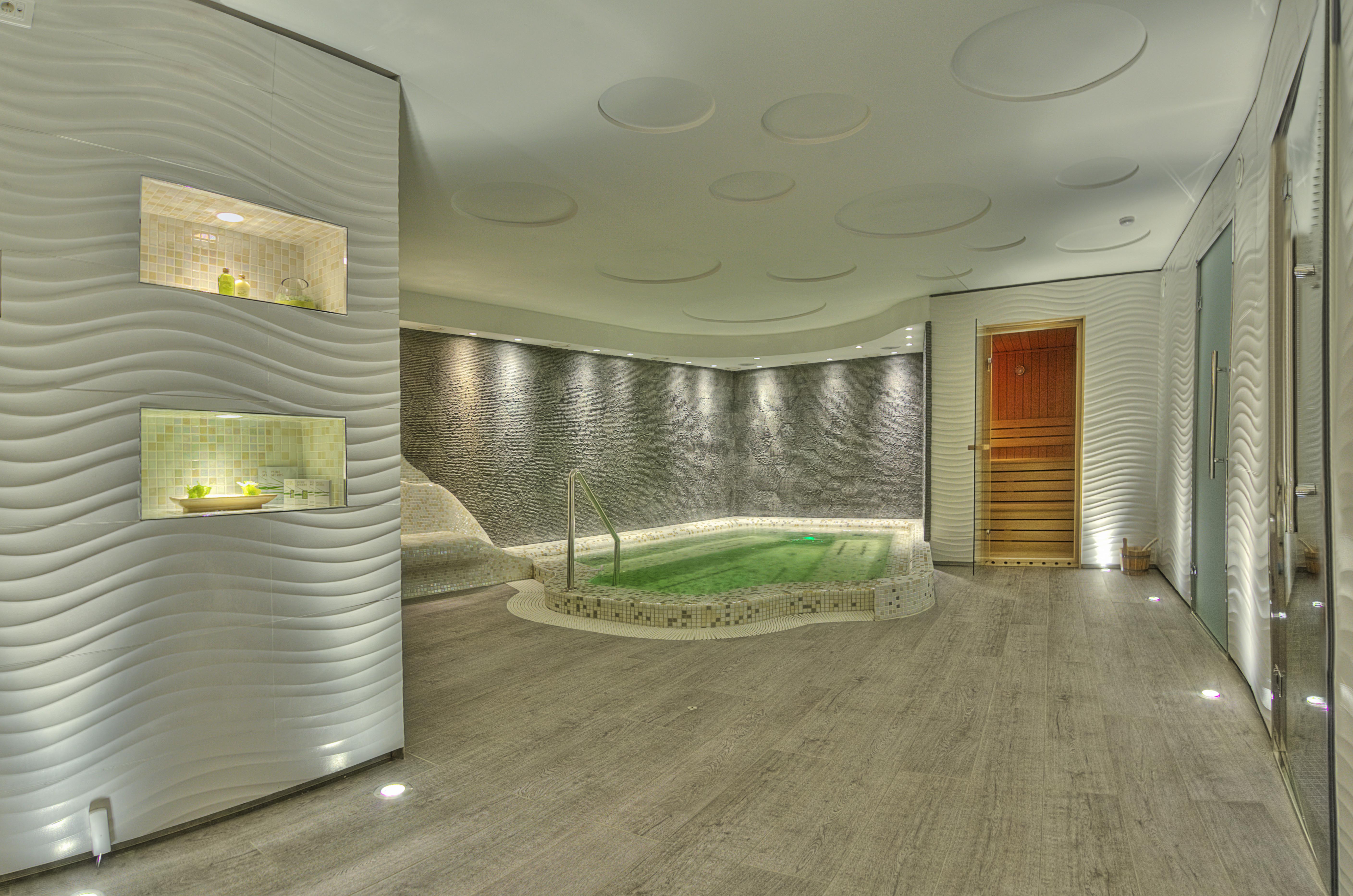 a room with a jacuzzi and a wood floor