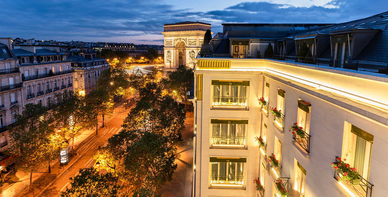 a building with a arch and trees in the background