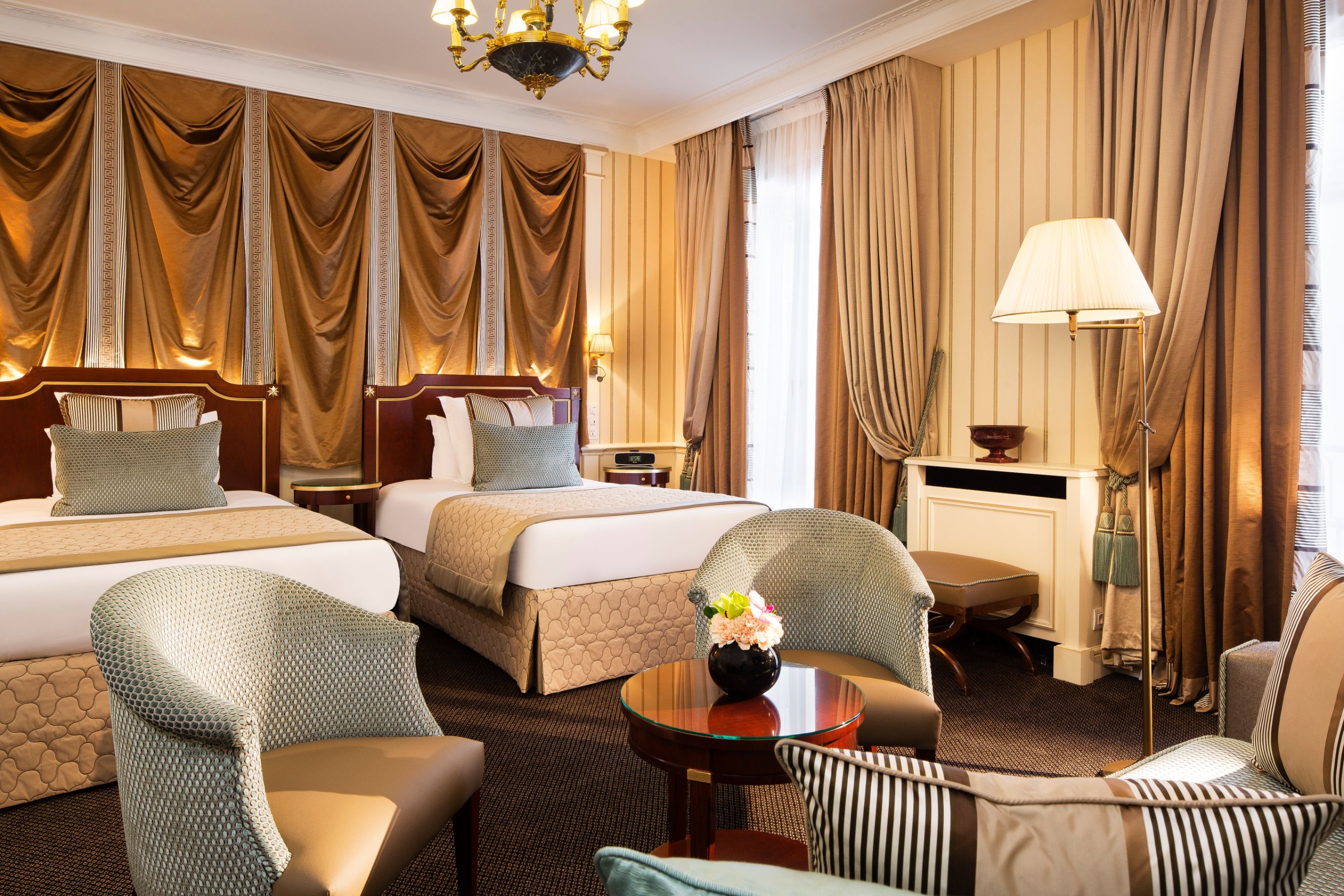 a room with two beds and a table