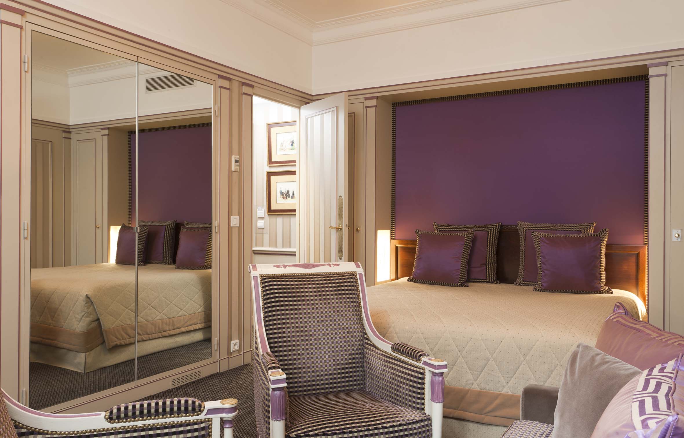 a bedroom with a bed and a mirror