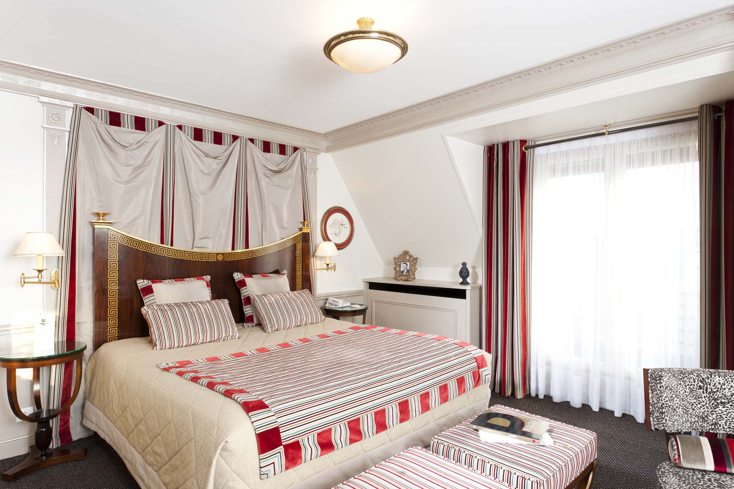 a bed with red and white striped covers