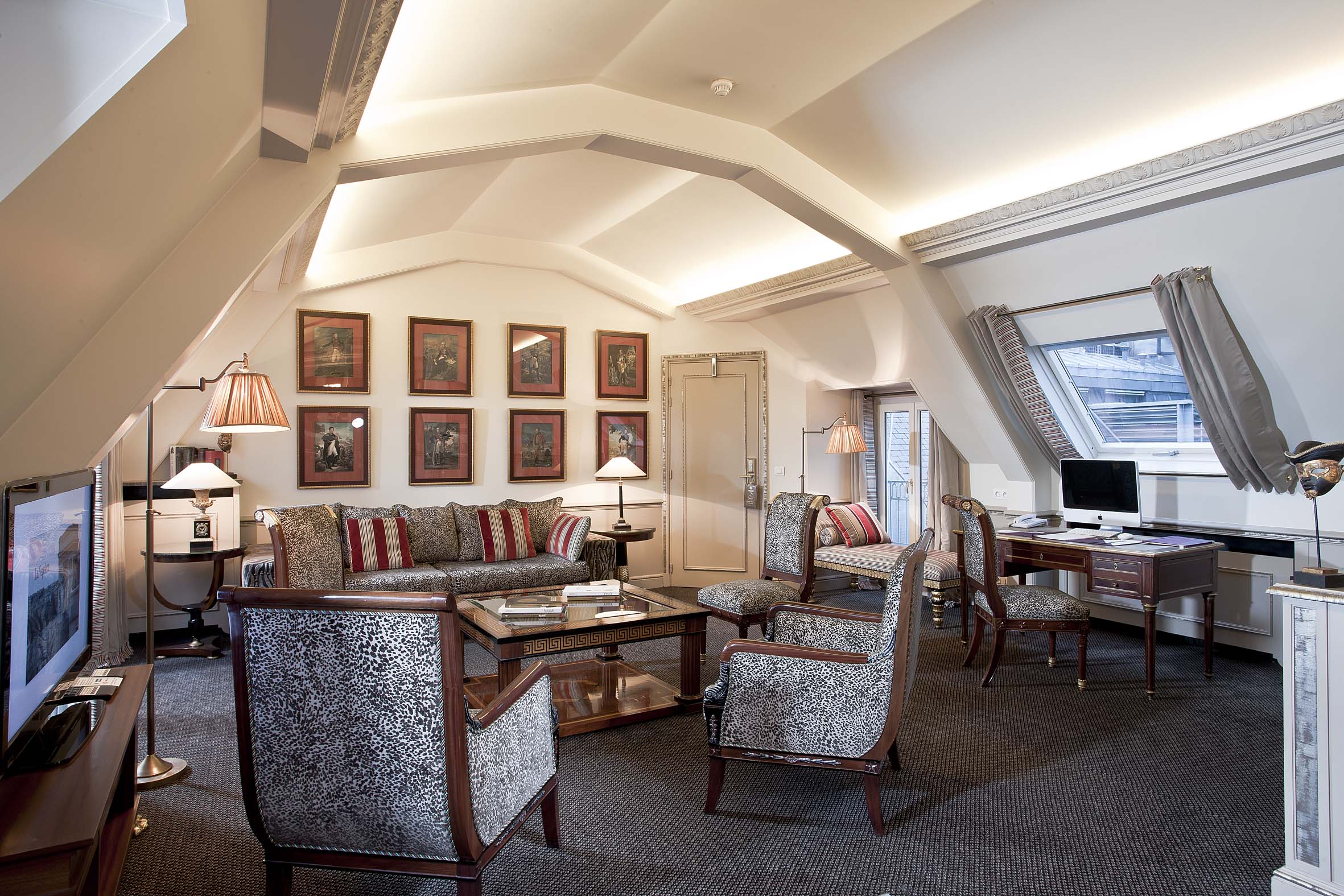 a room with a desk and chairs