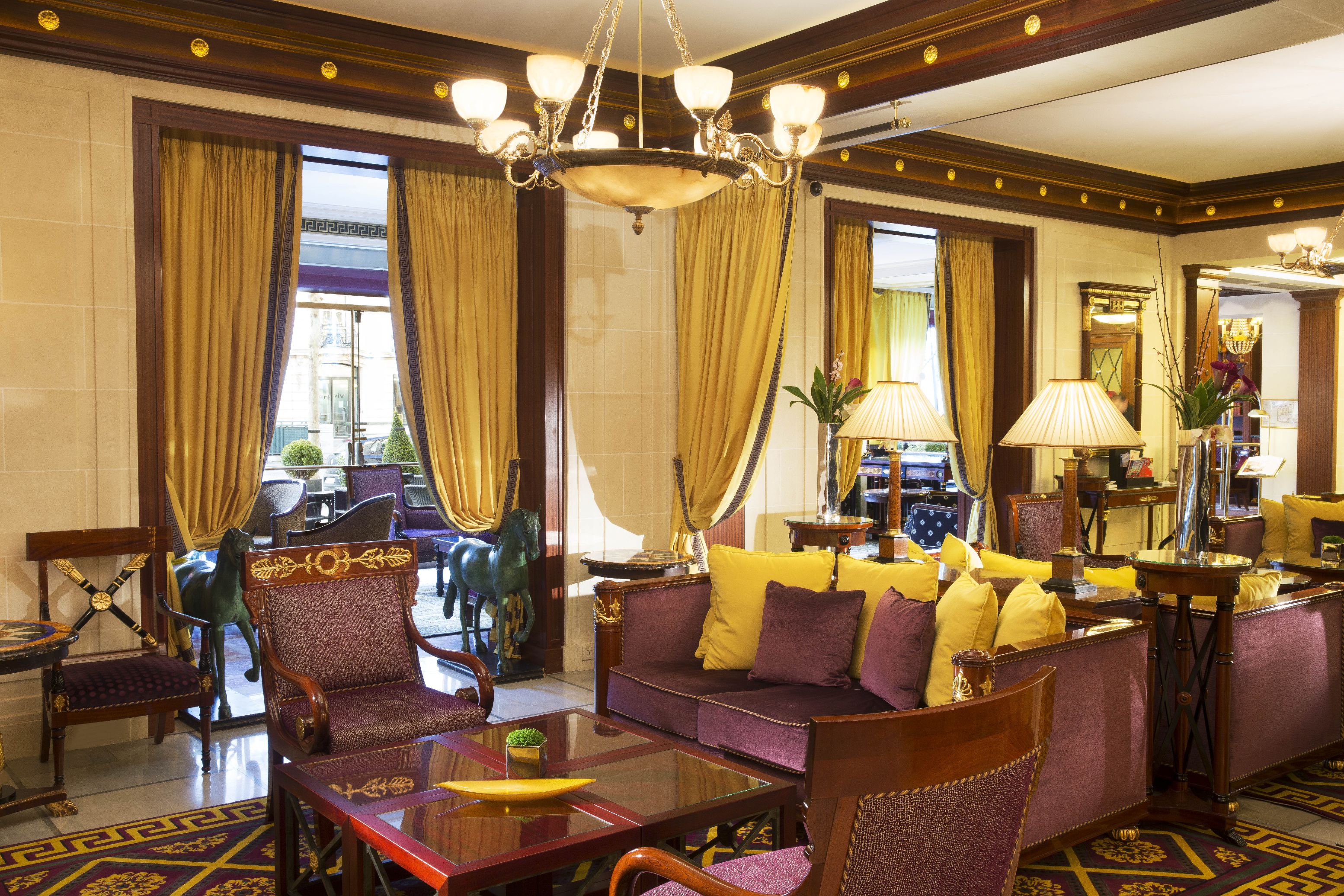 a room with a couch and chairs