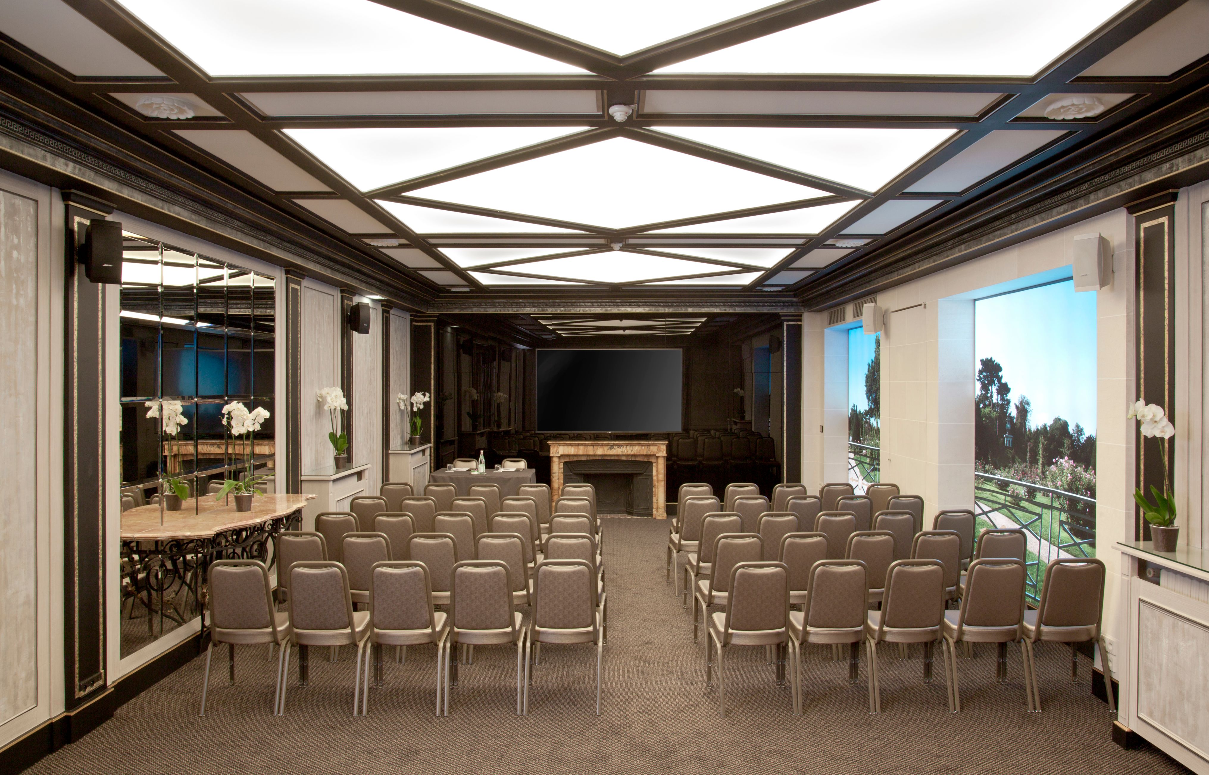 a room with chairs and a television