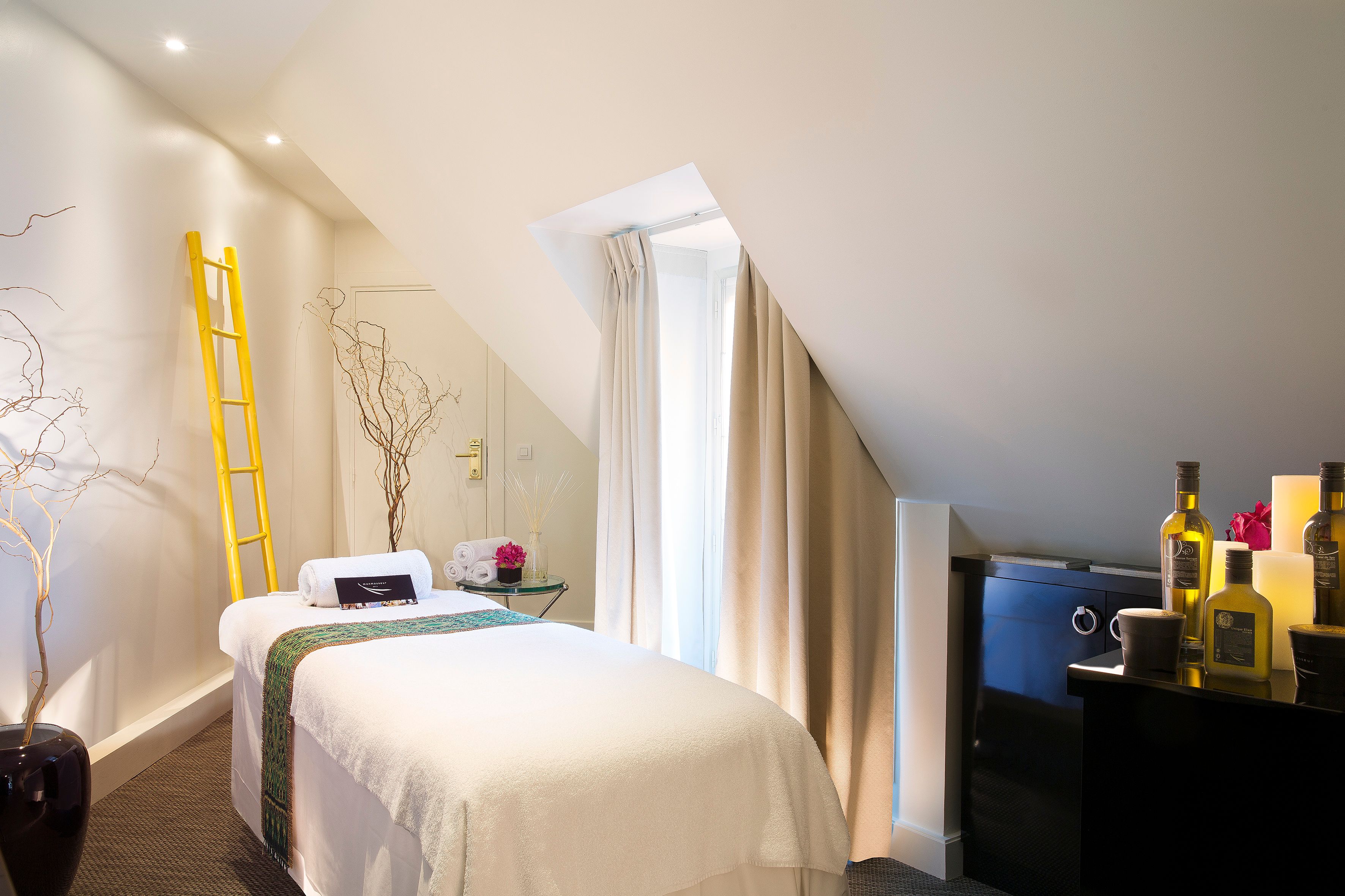 a bedroom with a bed and a yellow ladder
