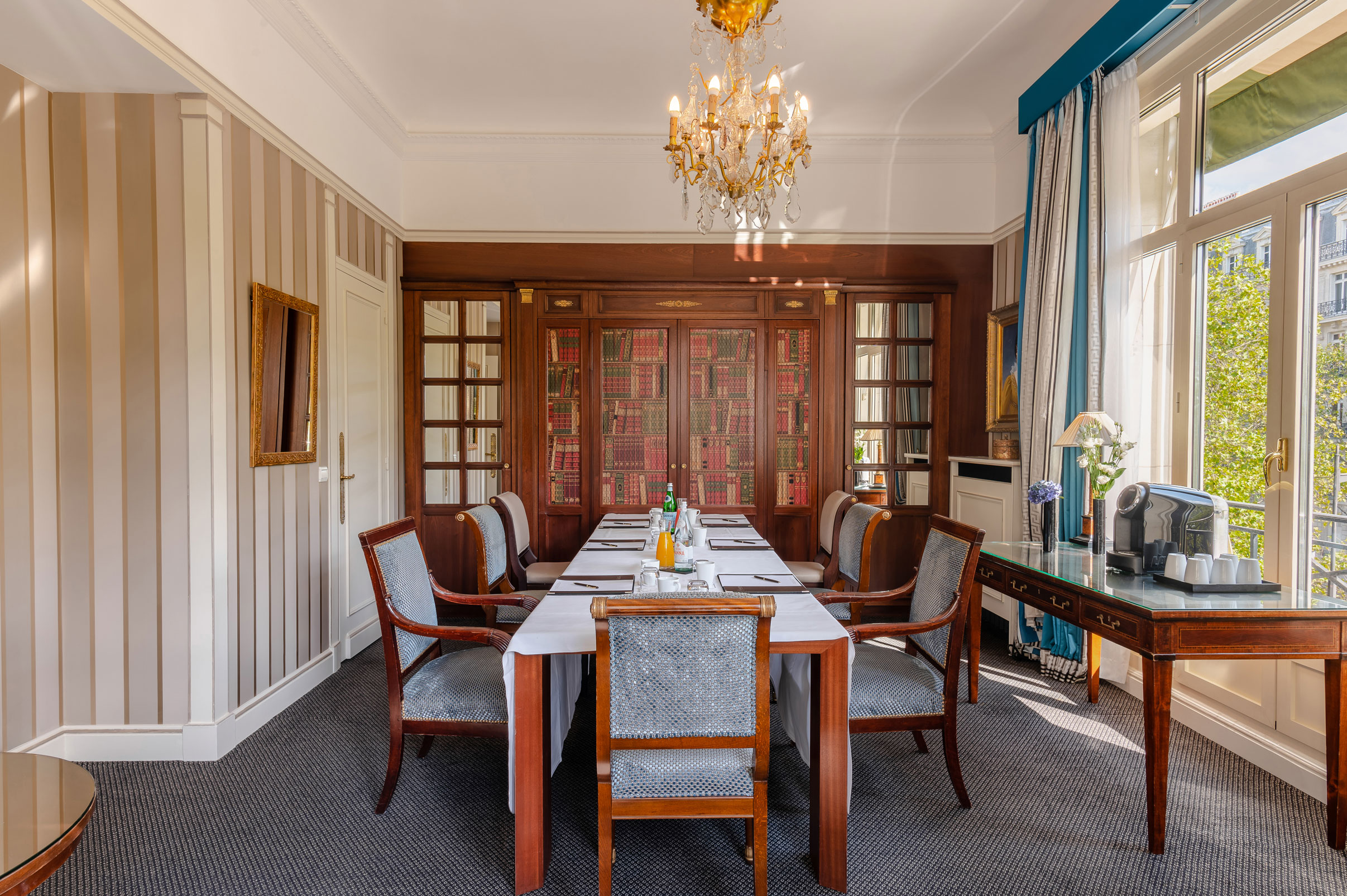 a dining room with a chandelier and chairs