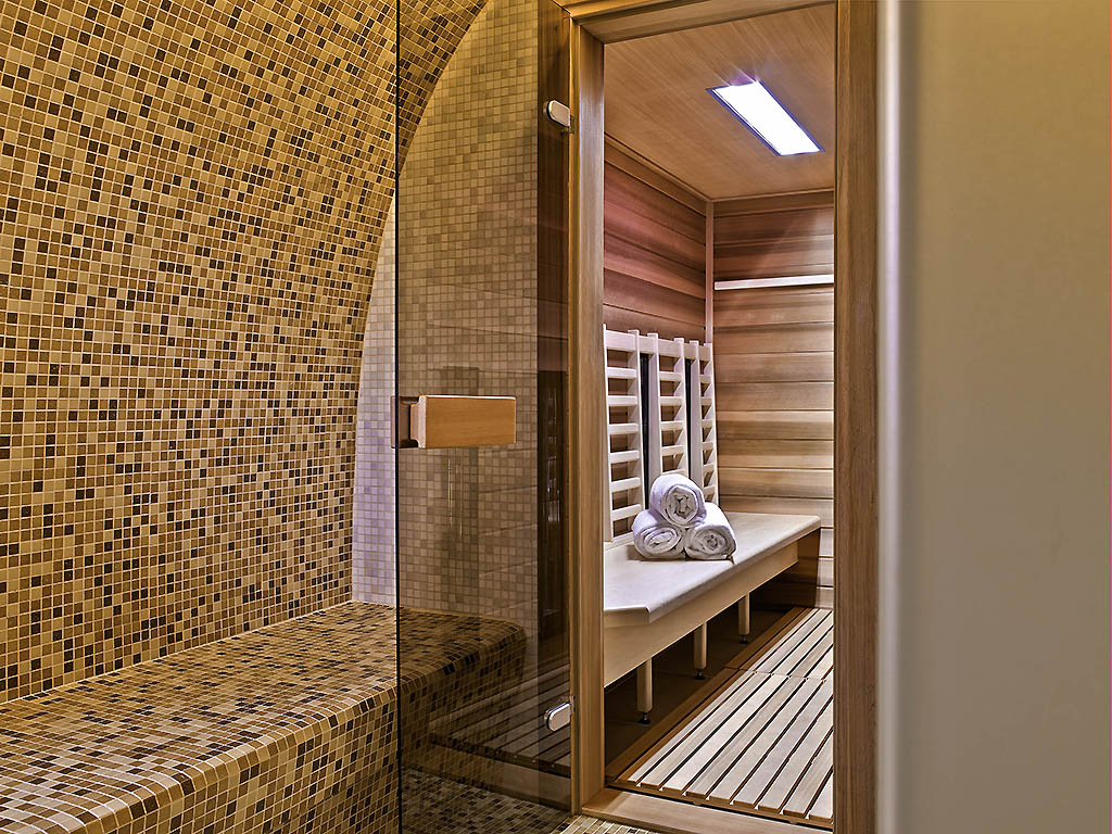 a sauna with a bench and towels