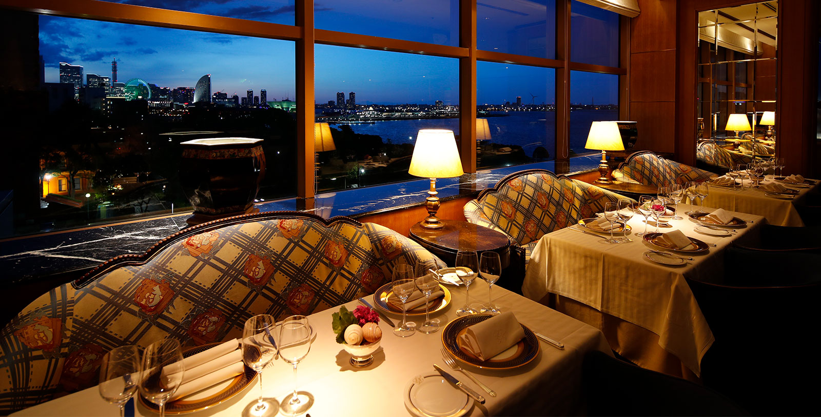a table set up with a view of a city and a river