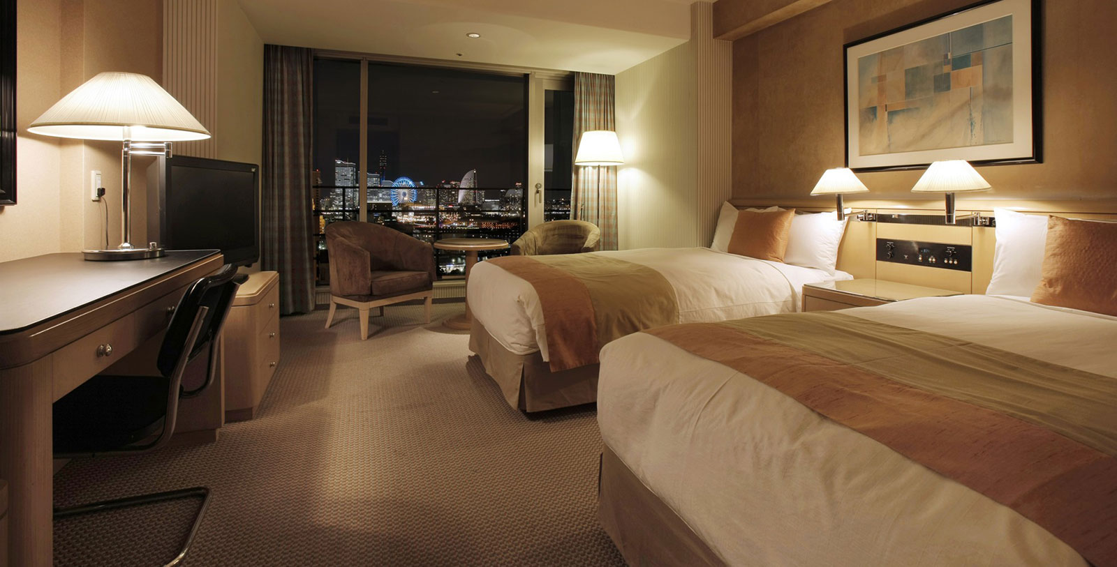 a hotel room with two beds and a window