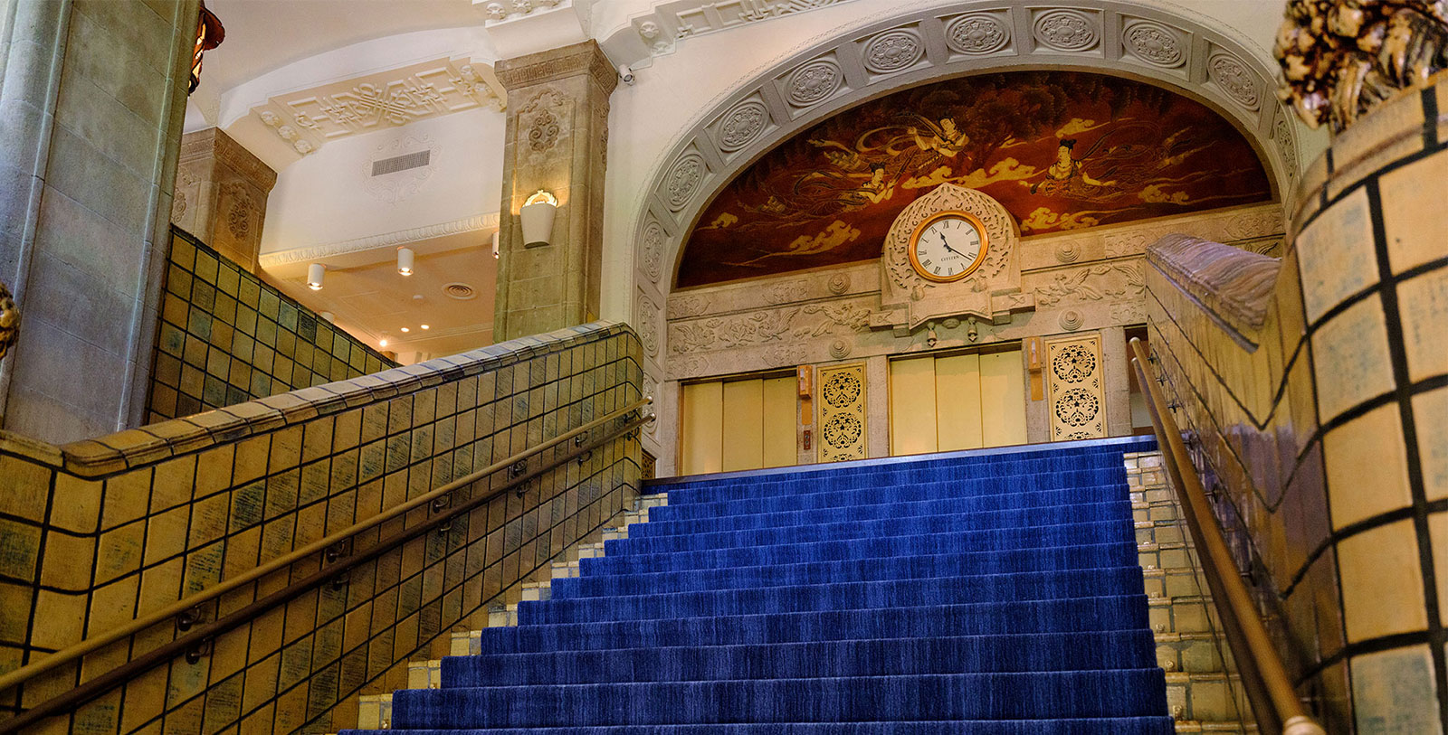 a blue carpeted stairs in a building
