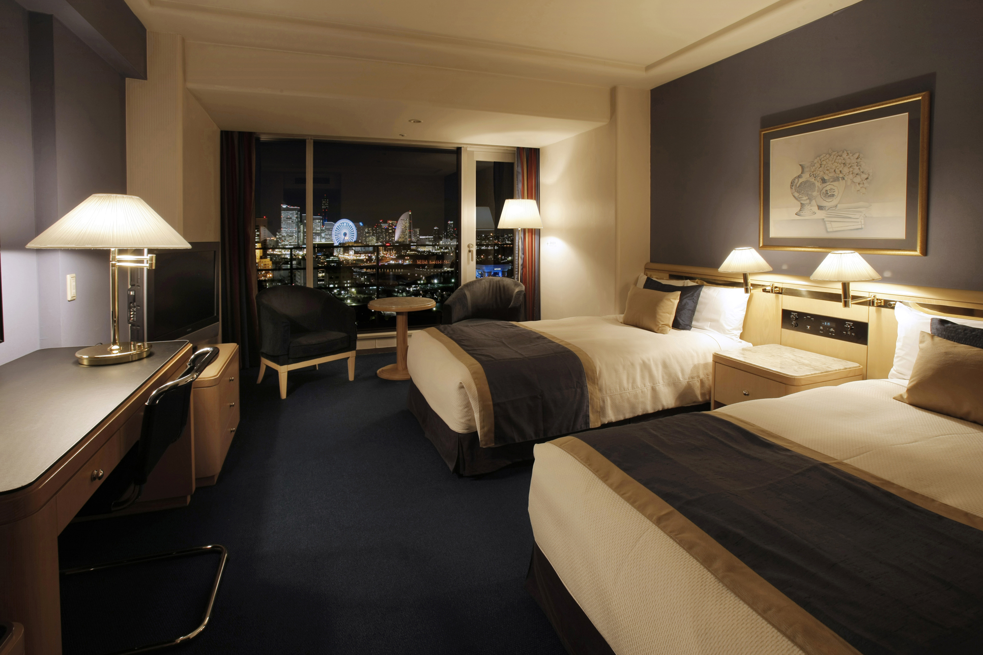 a hotel room with two beds and a television