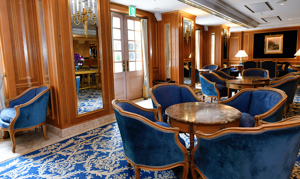 a room with blue chairs and tables
