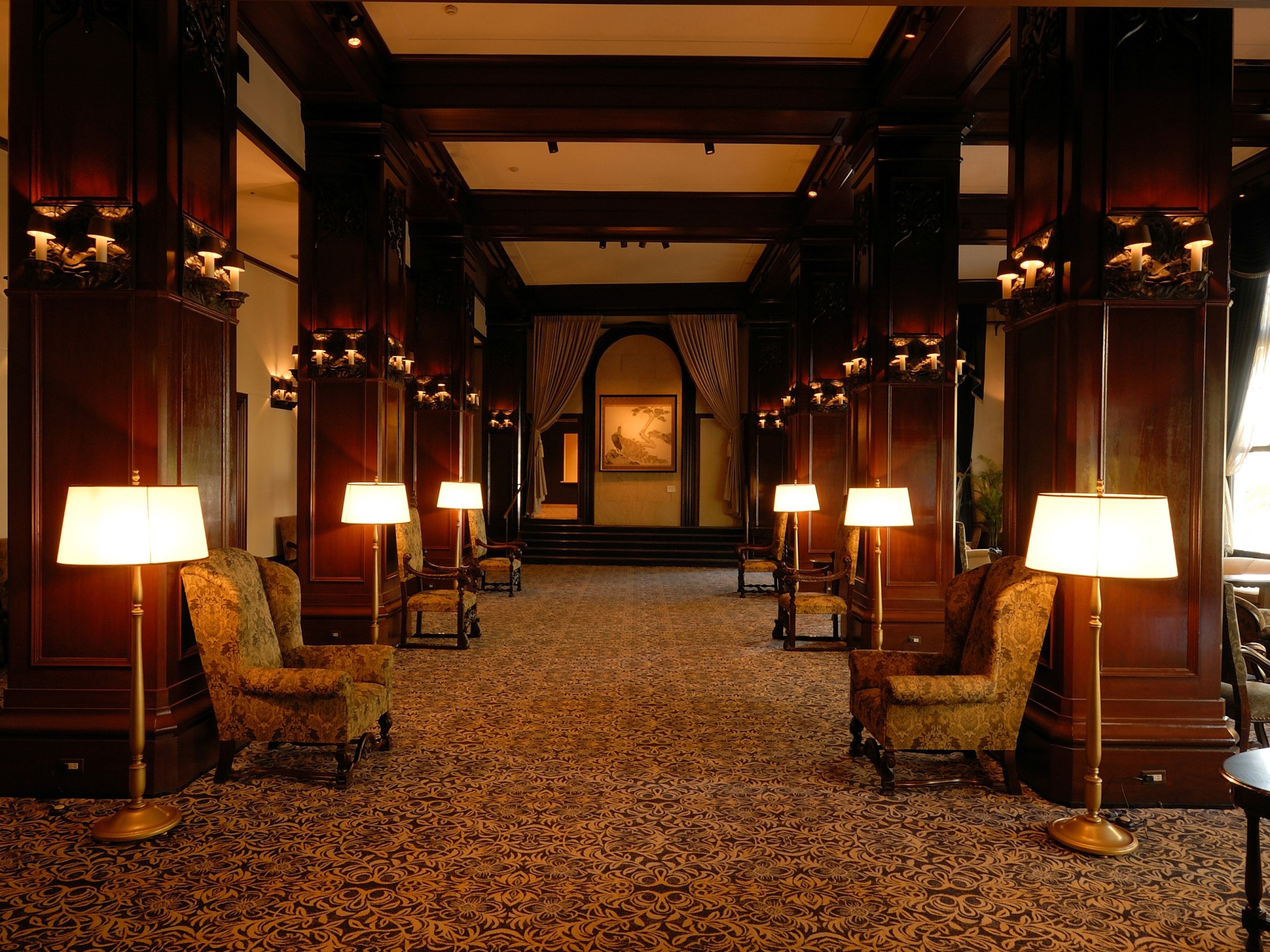 a room with chairs and lamps