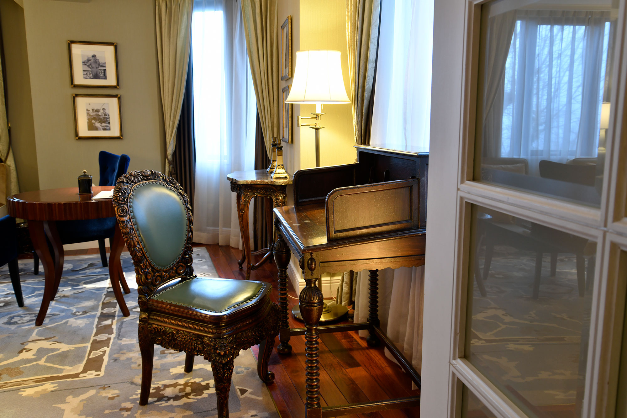 a room with a piano and chairs