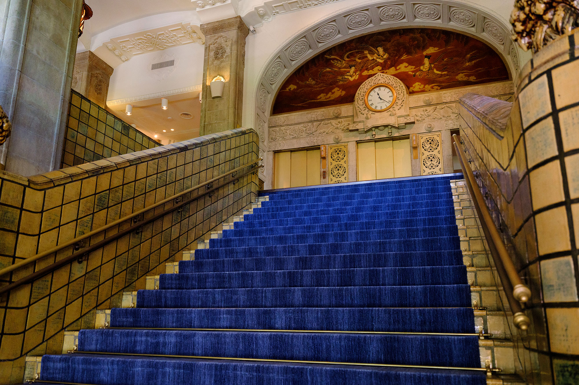 a blue carpeted stairs in a building