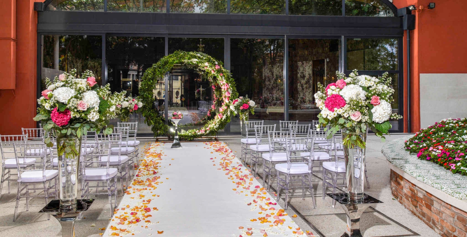 a wedding ceremony with chairs and flowers