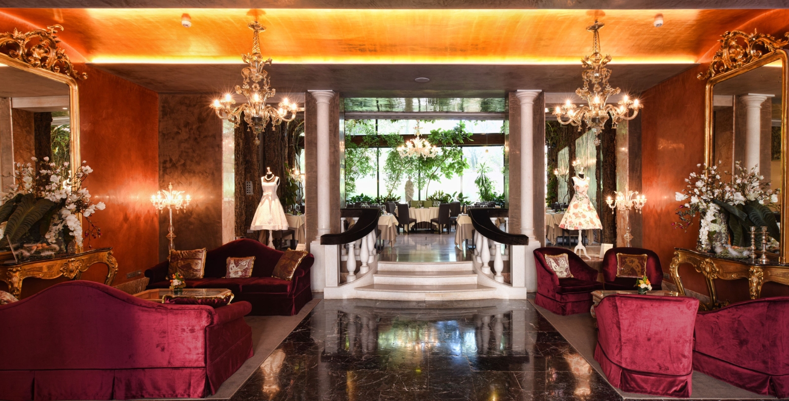 a room with a staircase and chandeliers
