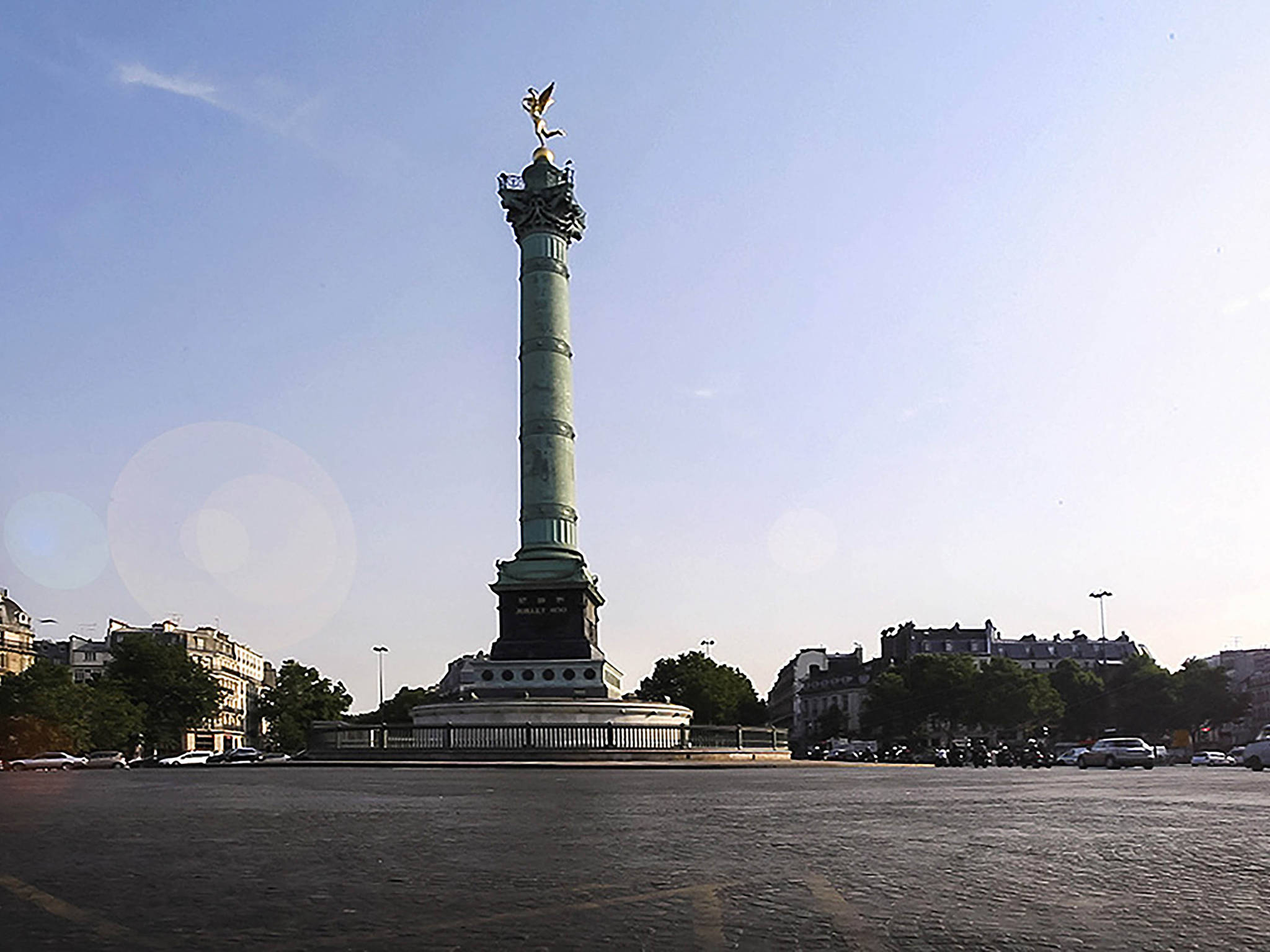 a tall monument with a statue on top