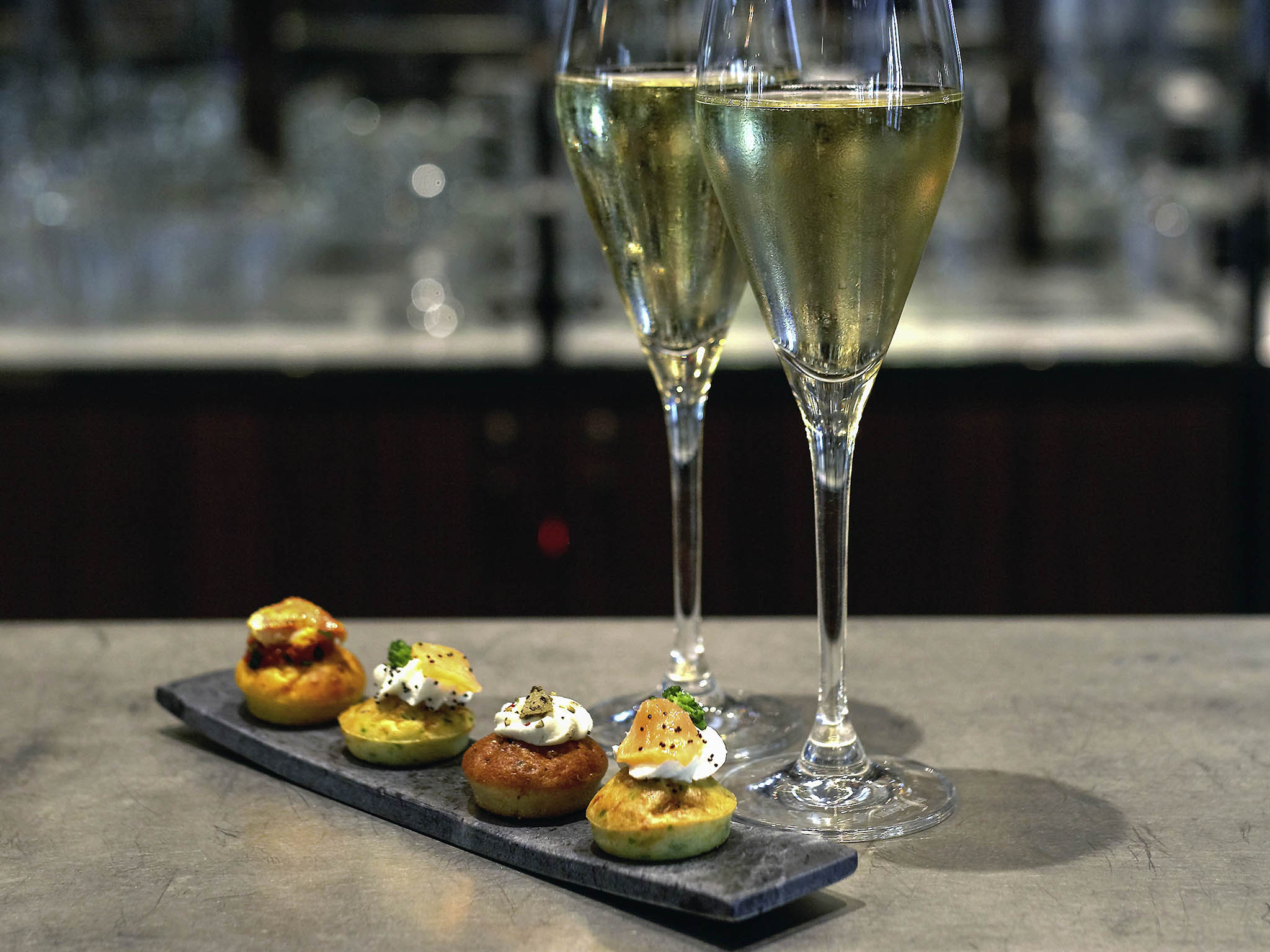 a glass of champagne next to food