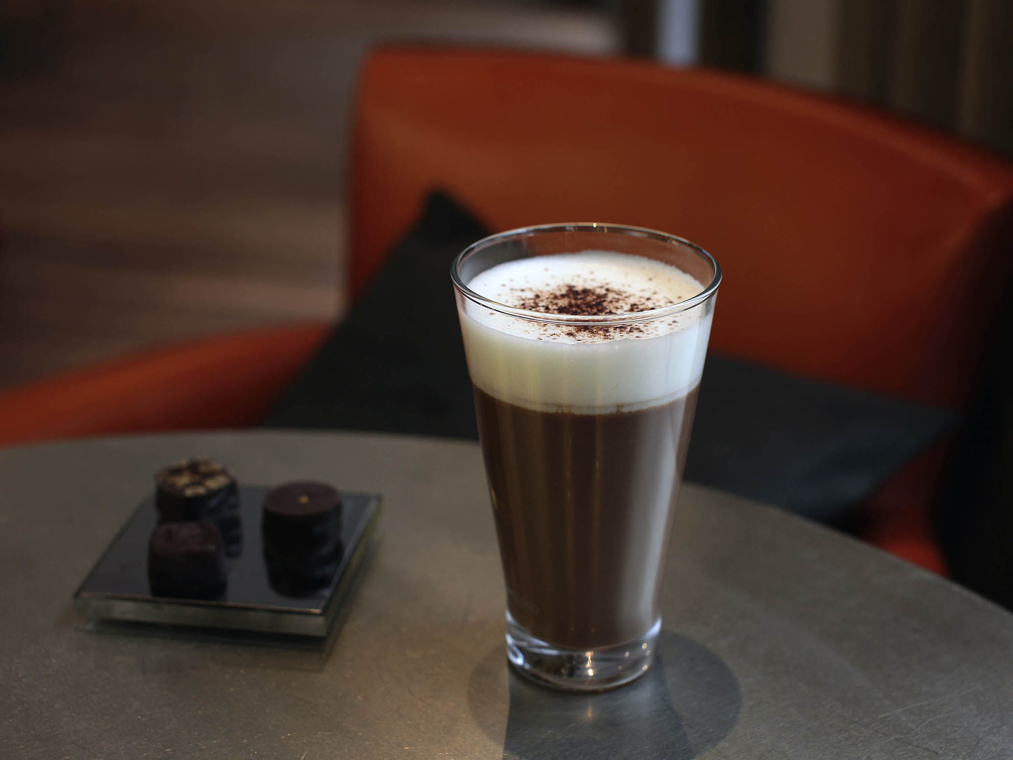 a glass of chocolate milkshake on a table