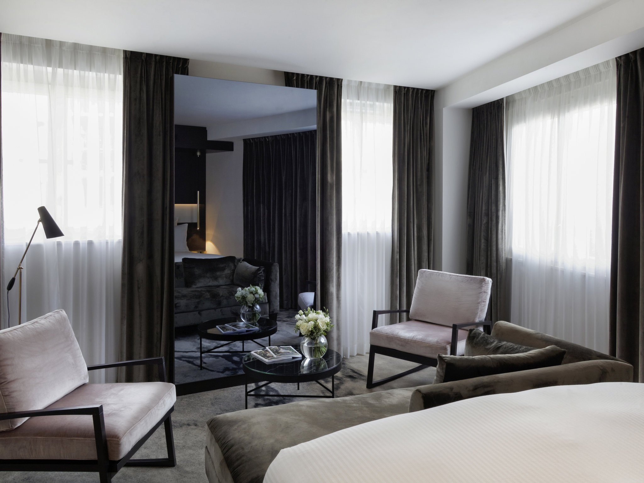 a room with a large mirror and chairs