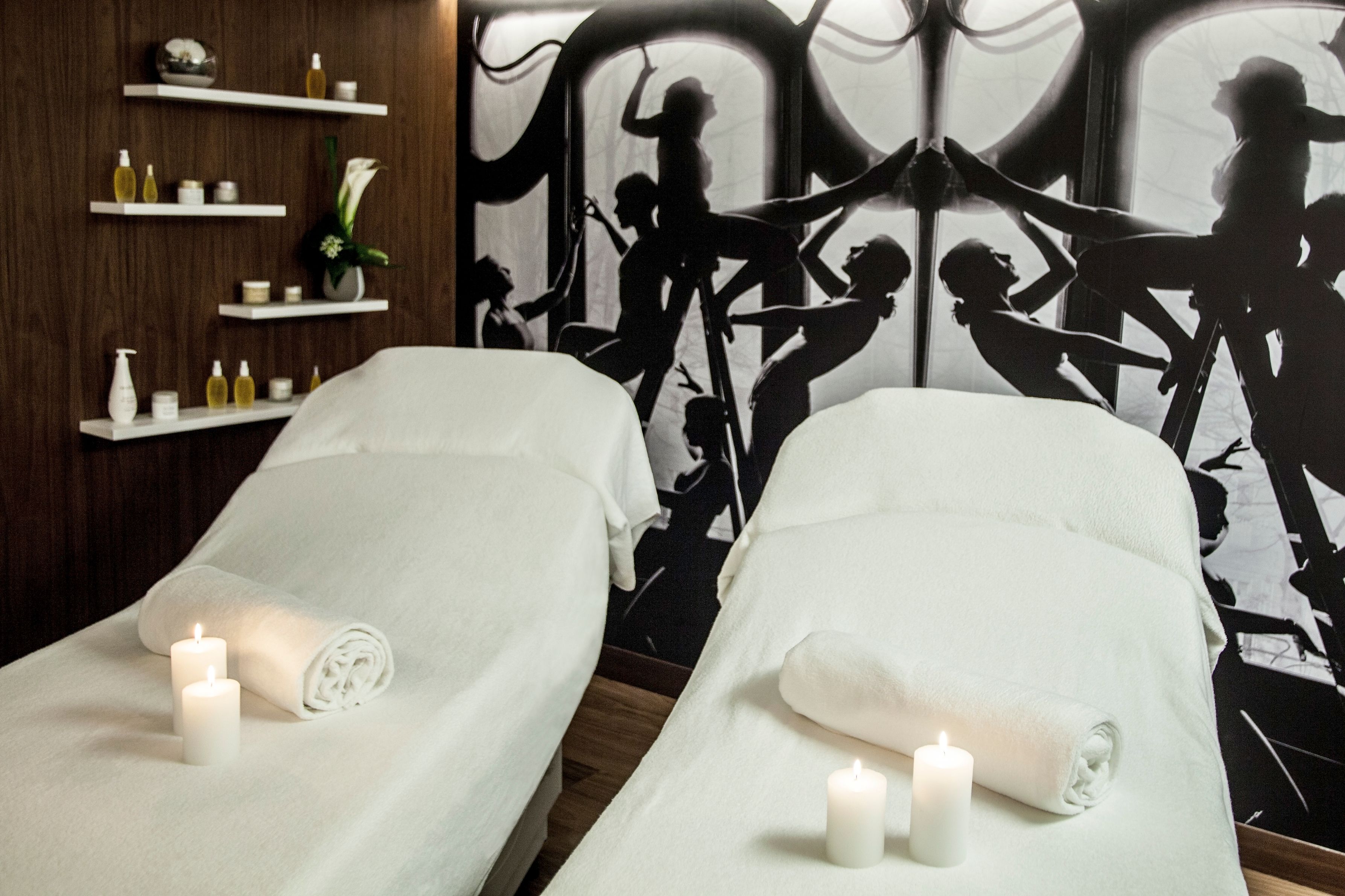 a massage room with two beds